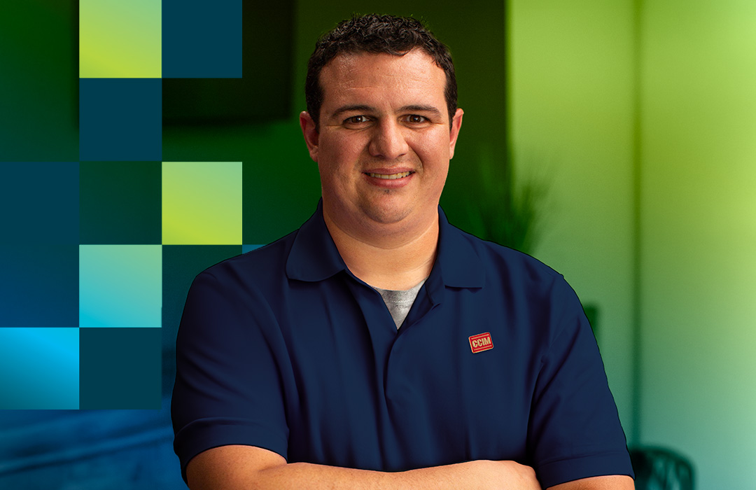 CCIM with arms crossed smiling at camera