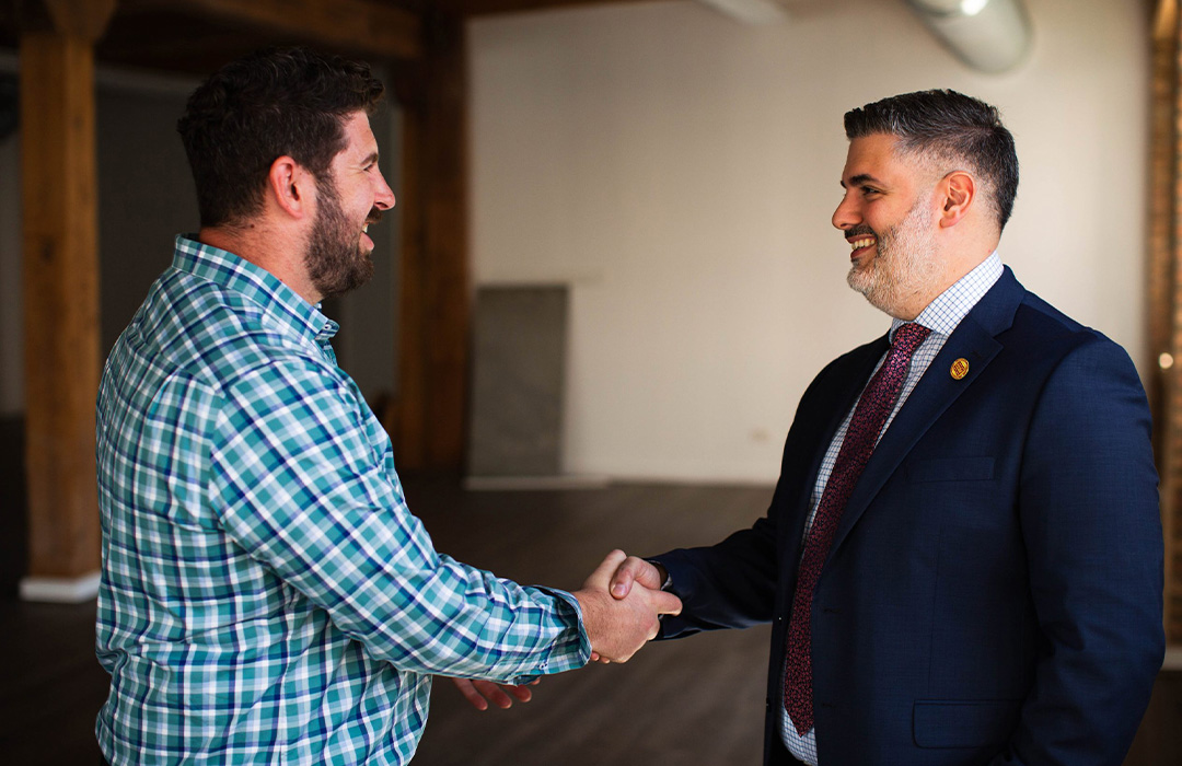 Image of two men shaking hands